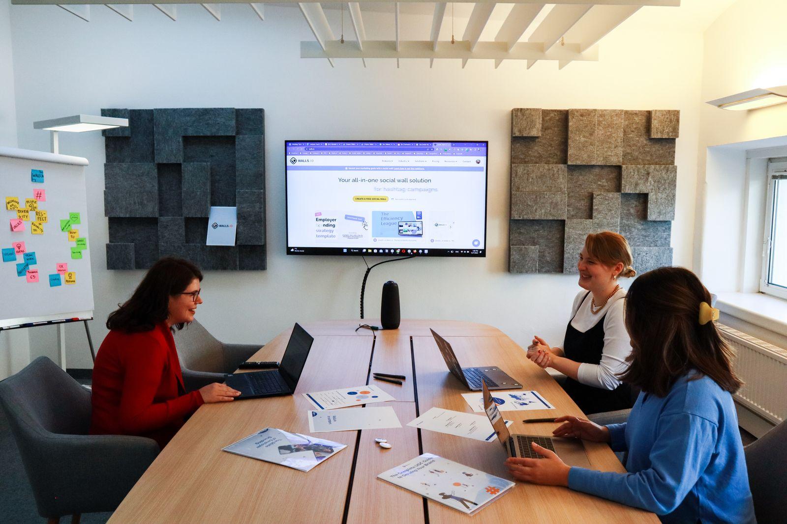 A marketing team meeting with laptops